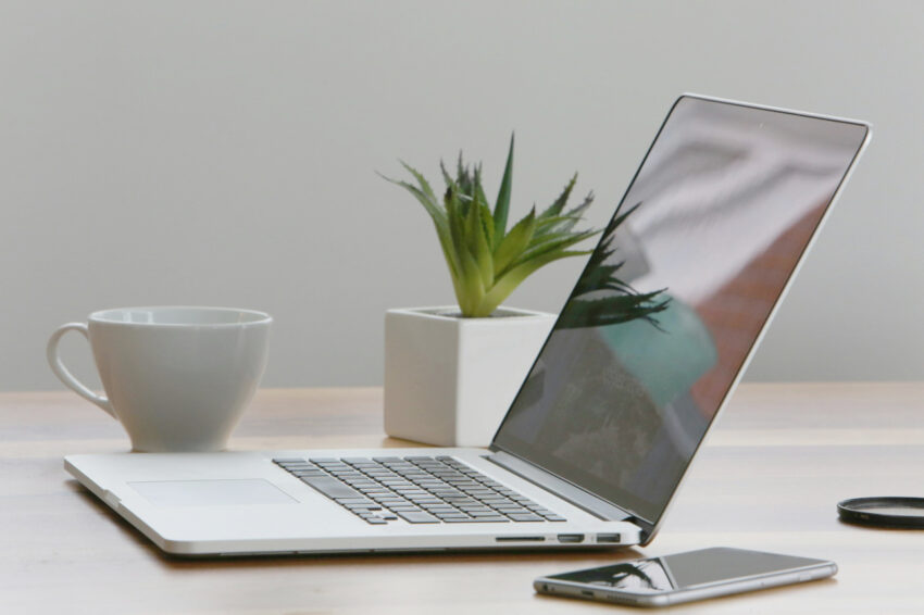 laptop on table with plant